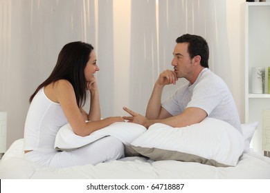 Couple Talking In Bedroom
