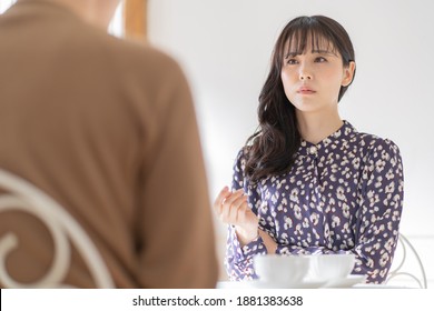 Couple Talking In A Cafe