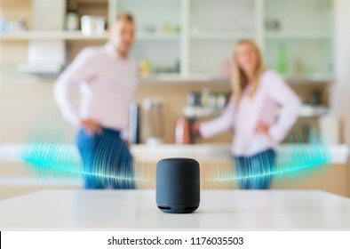 Couple Talking And Listening To Smart Speaker At Home