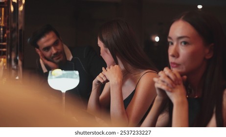 Couple talking at sitting bar with Margarita cocktail savoring sour tasty drink in happiness moment meeting while woman waiting friends at front view at luxurious counter vibrant nightclub. Vinosity. - Powered by Shutterstock