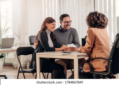 Couple talking to their insurance agent on a meeting