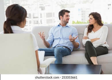 Couple talking with their therapist in the office