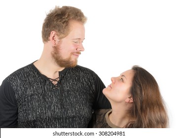 Couple: Tall Man And Short Woman Smiling And Looking At Each Other