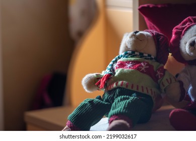 Couple Of Teddy Bears Wearing Woolen Winter Sweaters In Small Room On Soft Light On Out Of Focus Background