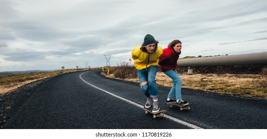 Couple Of Teenagers Having Fun Skating And Making Downhill In Iceland