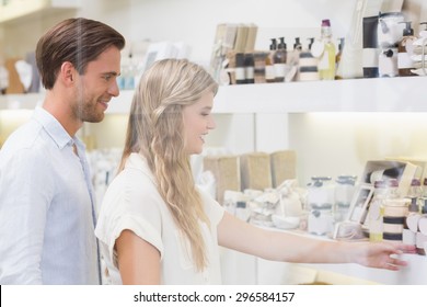 A Couple Testing A Sample Of Beauty Products In The Mall