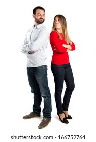 Couple with their arms crossed over isolated background 
