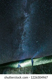 A Couple And Their Dog Star Gazing On A Clear Colorado Night.