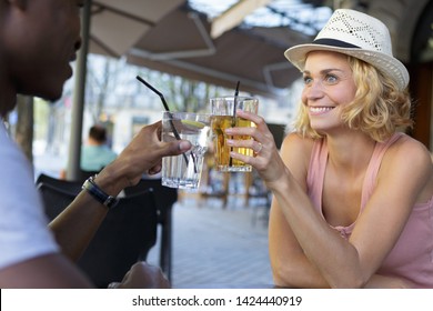 Couple Toasting With Cocktails Outdoors