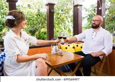 Couple toasting with a glass of wine on a date - Powered by Shutterstock