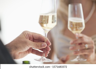 Couple toasting glasses of champagne, close up