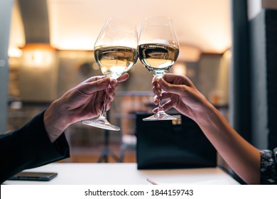 Couple toasting with white wine. closeup on the hands. - Powered by Shutterstock