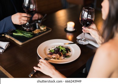 Couple Toasting Wineglasses In A Luxury Restaurant