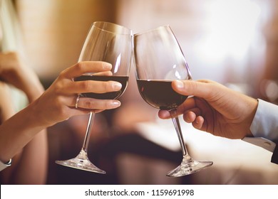 Couple toasting wineglasses in a restaurant - Powered by Shutterstock