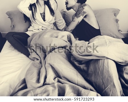 Similar – Young woman caressing man face lying over bed