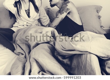 Similar – Young woman caressing man face lying over bed