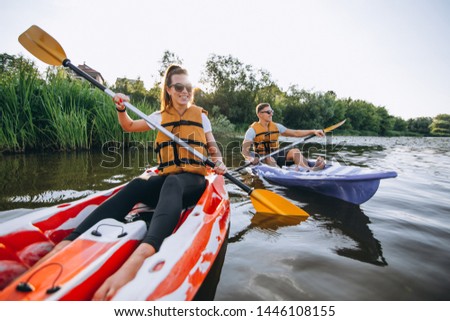Couple together kayaking on the river