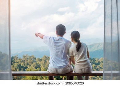 Couple tourist relaxing and looking mountain view at countryside home or homestay in the morning. Vacation, together travel, honeymoon, blogger, journey, trip and relaxing concept - Powered by Shutterstock