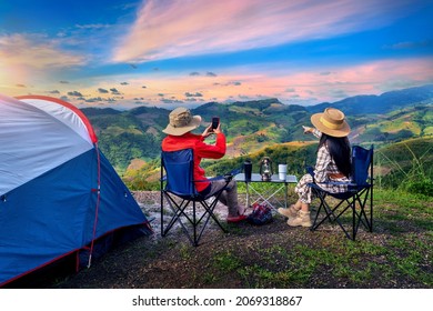 Couple tourists enjoying in the camping on mountains, Traveler take a photo at viewpoint. - Powered by Shutterstock