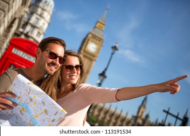 Couple of tourists in London holding a map