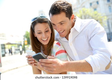 Couple Of Tourists In Madrid Using Smartphone