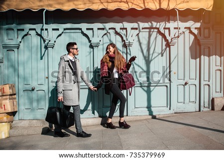 Couple of tourists walking down the street