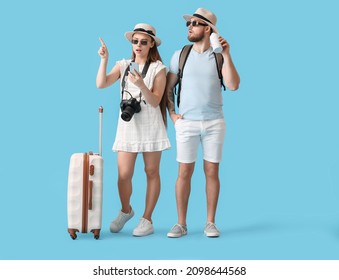 Couple of tourists on color background