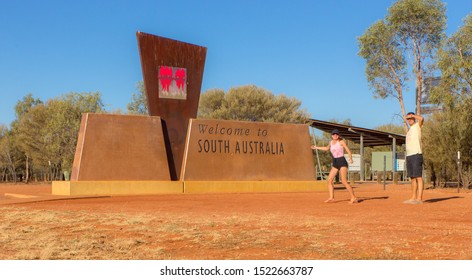 Couple Of Tourists At A Road Sign On The State Border South Australia - Outback Australia 1.10.2019
