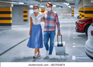 Couple Of Tourists In Underground Airport Parking Lot