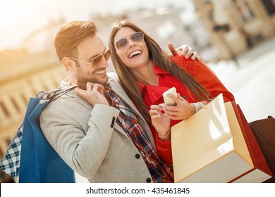 Couple of tourists walking in a city street - Powered by Shutterstock