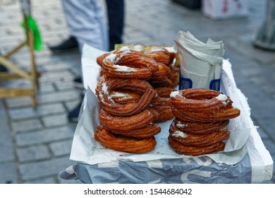 Couple Of Traditional Ring Desserts - Syrup Soaked Pastry - On Street Vendor Table. Deep Fried Sugar Dough.