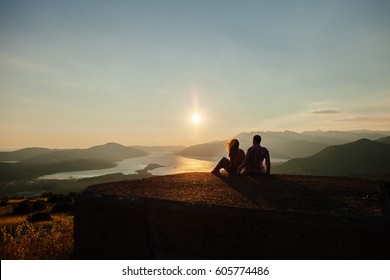 couple travel mountains at sunset. Picturesque landscape. Travelling Europe at honeymoon. Mountains and sea view at sunset. - Powered by Shutterstock