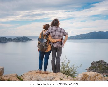 Couple Traveler Explore Ruins Castle Of Simena With View Of Sea Bay And Kekova Island With Famous Flooded City. Tourist Attractions In Turkey.