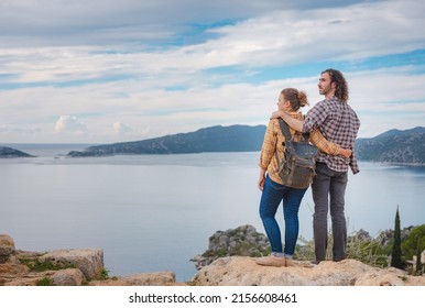 Couple Traveler Explore Ruins Castle Of Simena With View Of Sea Bay And Kekova Island With Famous Flooded City. Tourist Attractions In Turkey.