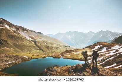 Couple Travelers Holding Hands On Mountain Cliff Over Lake Together Love And Travel Lifestyle Wanderlust Concept Adventure Vacations Outdoor Aerial View
