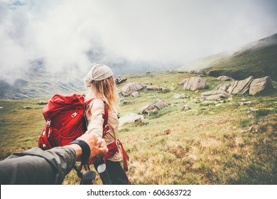 Couple Travelers Man And Woman Follow Holding Hands At Foggy Mountains Landscape On Background Love And Travel Happy Emotions Lifestyle Concept. Young Family Traveling Active Adventure Vacations