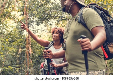 Couple trekking in the forest together - Powered by Shutterstock