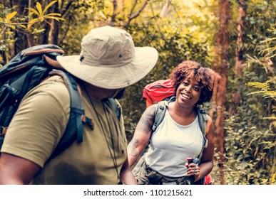 Couple trekking in the forest together - Powered by Shutterstock