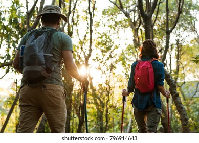 Couple Trekking Together In A Forest