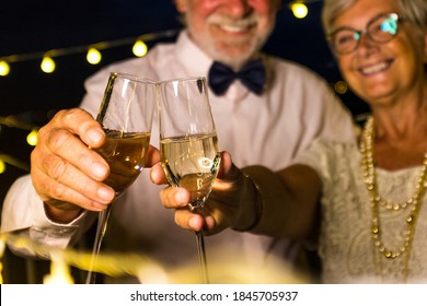 Couple Of Two Old And Mature Seniors Enjoying And Having Fun Together Celebrating The New Year Night Drinking And Clinking With Champagne