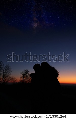 Couple under sunset stars galaxy