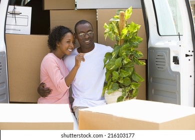 Couple Unloading Boxes From Van