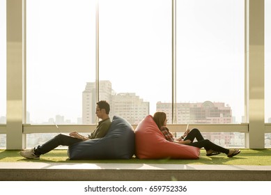 Couple Use Smartphone And Laptop In Afternoon, Technology Lifestyle Of New Generation Of Nomad Workers