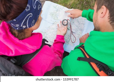 Couple using compass and map on their hike in the country - Shutterstock ID 153991787