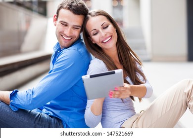 Couple Using Digital Tablet Outdoors 