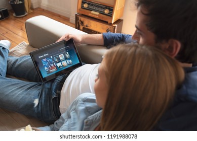 Couple using digital tablet for watching movie on VOD service. Video On Demand television internet stream multimedia concept