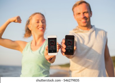 Couple Using Fitness App On Their Mobile Phones