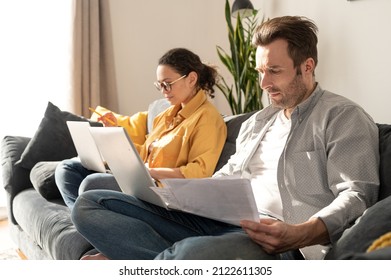 Couple using laptops for remote work on the sofa at home, focused spouses working on the distance, answering emails, doing paperworks in home atmosphere - Powered by Shutterstock - Get 15% off with code: PIKWIZARD15
