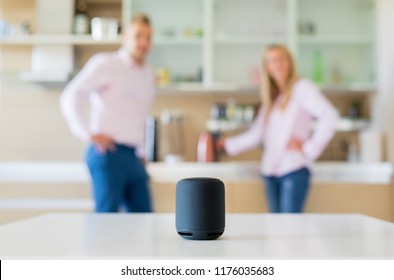 Couple Using Smart Speaker At Home