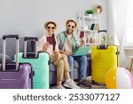 Couple vacation happy online tour registration, packing suitcase together, planning, preparing for travel or recreation. Pair dreaming of enjoyment, sea relaxation, going leisure trip, summer journey